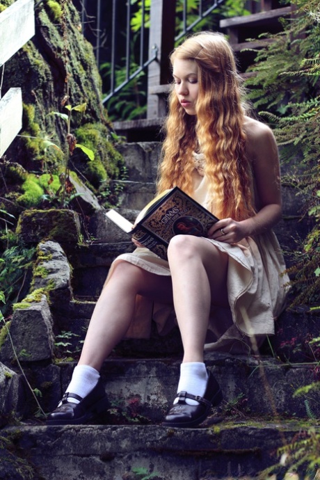 Молодая рыжеволосая Долли Литтл обнажается на ступеньках сада во время чтения картинка 3